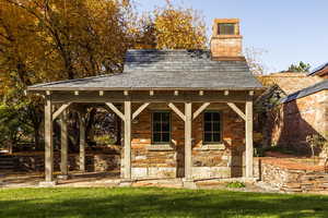 View of outbuilding with a lawn