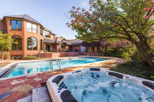 View of pool featuring an outdoor hot tub