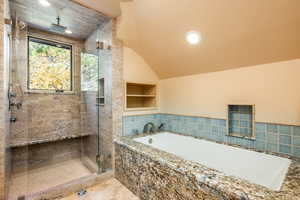 Bathroom with independent shower and bath and lofted ceiling