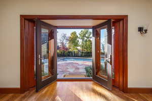 Doorway to outside featuring french doors and light hardwood / wood-style floors