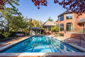 View of pool featuring a patio area and an outbuilding