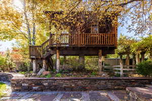 Rear view of property featuring a deck and a patio area