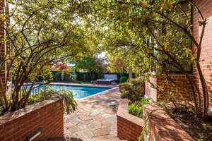 View of swimming pool with a patio area and a jacuzzi