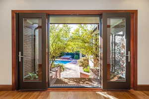 Doorway featuring plenty of natural light and light wood-type flooring