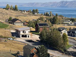 Drone / aerial view featuring a water and mountain view