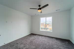 Empty room with carpet floors and ceiling fan