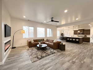 Living room with hardwood / wood-style flooring and ceiling fan