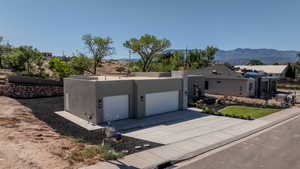 View of front facade with a mountain view and a garage