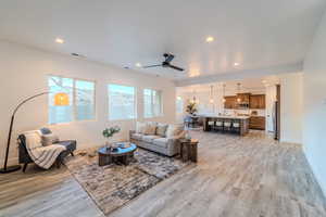 Living room featuring light wood-type flooring and ceiling fan