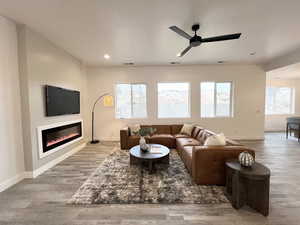 Living room featuring ceiling fan and light wood-type flooring