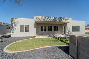 Rear view of property with a yard and a patio area