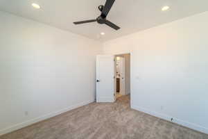 Spare room with ceiling fan and light carpet