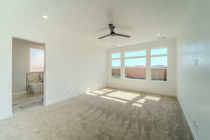 Empty room with light colored carpet and ceiling fan