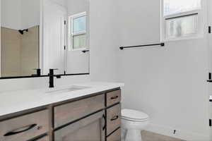 Full bathroom with vanity, tile patterned floors, and a shower