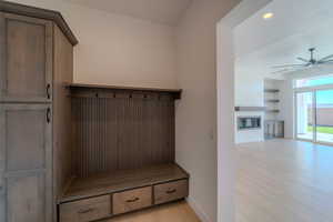 Mudroom with ceiling fan and light wood-type flooring