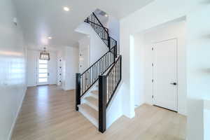 Entrance foyer featuring light hardwood / wood-style floors