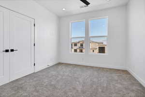 Carpeted empty room featuring recessed lighting and a ceiling fan