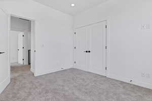Unfurnished bedroom with carpet flooring and a closet