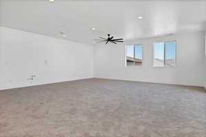 Carpeted spare room with recessed lighting and a ceiling fan