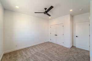 Unfurnished bedroom with a closet, light colored carpet, and ceiling fan