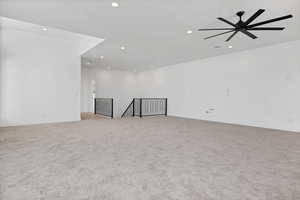 Spare room featuring recessed lighting, light colored carpet, and ceiling fan