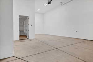 Garage with baseboards and a garage door opener