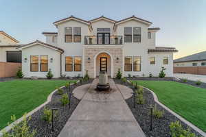 Mediterranean / spanish house featuring a balcony and a yard