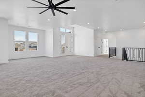 Unfurnished living room with carpet flooring, ceiling fan, and recessed lighting