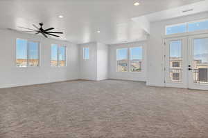 Unfurnished living room featuring carpet flooring, recessed lighting, french doors, and ceiling fan