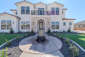 Mediterranean / spanish home with a balcony and a front yard