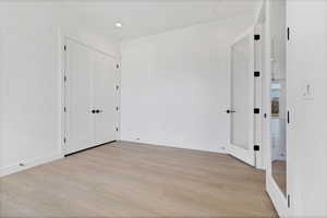 Spare room featuring light wood-style floors and recessed lighting