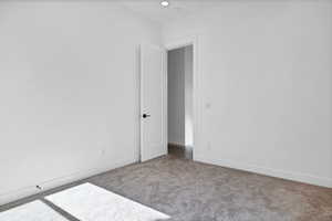 Unfurnished room with carpet flooring and baseboards