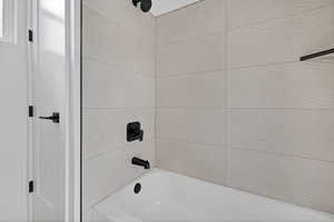 Bathroom featuring washtub / shower combination