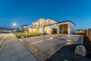 View of front of home with a garage and a balcony