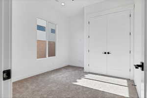 Unfurnished bedroom with carpet floors, a closet, and recessed lighting