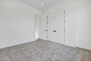 Unfurnished bedroom with carpet floors and a closet