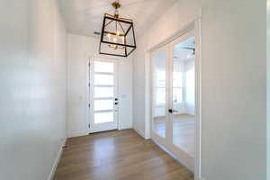 Entryway featuring a chandelier, light hardwood / wood-style flooring, and french doors