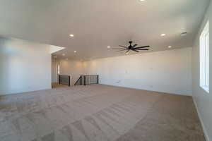 Unfurnished room featuring light carpet and ceiling fan