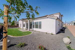 Rear view of property featuring a patio, cooling unit, and a yard