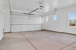 Garage with a garage door opener and baseboards
