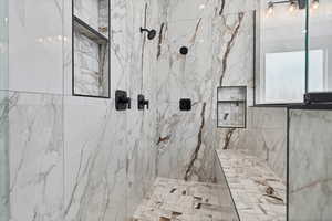 Bathroom featuring a marble finish shower