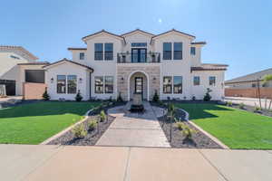 Mediterranean / spanish home with a balcony and a front yard