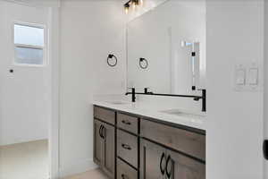 Bathroom with double vanity and tile patterned flooring