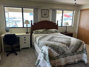 Bedroom featuring a closet, light colored carpet, and a textured ceiling