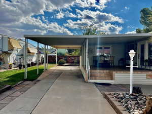 View of parking featuring a carport