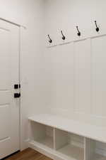 Mudroom with wood-type flooring