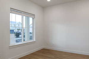 Spare room with wood-type flooring