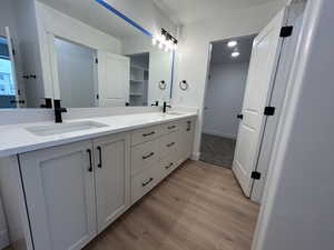 Bathroom with hardwood / wood-style floors and vanity