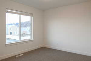 Carpeted spare room featuring a mountain view