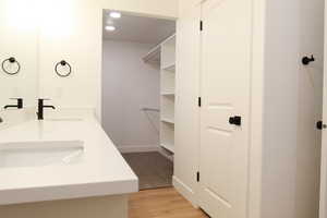 Bathroom featuring hardwood / wood-style floors and vanity